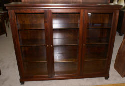 Dark mahogany triple glass door bookcase