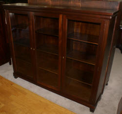 Dark mahogany triple glass door bookcase