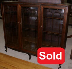 Petite walnut triple glass door antique bookcase