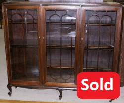 Petite walnut triple glass door antique bookcase