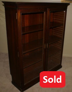 Antique walnut two door bookcase with slide in shelves