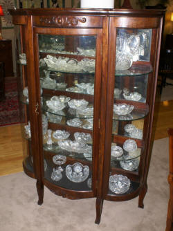 Walnut triple bow front antique china cabinet