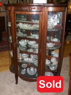 Walnut triple bow front antique china cabinet