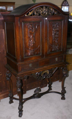 walnut heavily carved antique blind door crystal cabinet with built in butlers desk