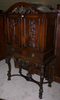 walnut heavily carved antique blind door crystal cabinet with built in butlers desk