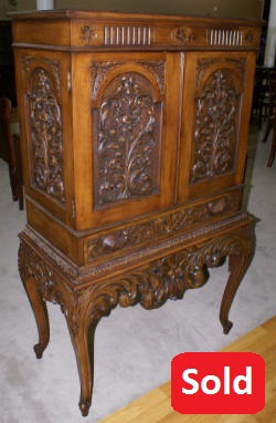 Heavily carved antique walnut blind door crystal cabinet 