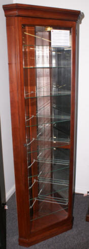 Mahogany finish lighted corner curio cabinet by Pulaski Furniture Company
