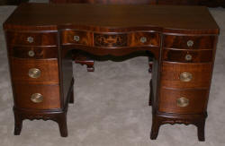 Urn inlaid mahogany kneehole desk