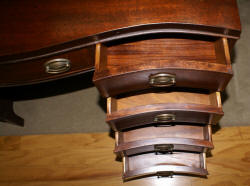 Mahogany pencil inlaid serpentine front antique desk