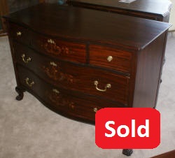 Heavily inlaid antique mahogany bow front dresser