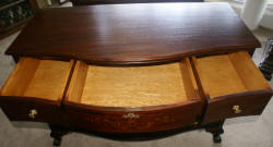 Heavily inlaid antique mahogany bow front dresser