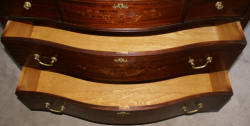 Heavily inlaid antique mahogany bow front dresser