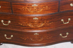 Heavily inlaid antique mahogany bow front dresser