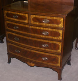 Heavily inlaid mahogany bow front dresser