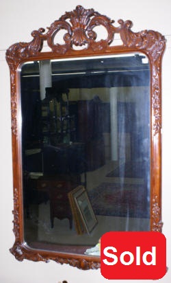 heavily carved french antique mirror
