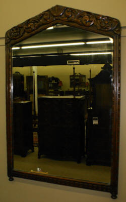 heavily carved walnut antique mirror