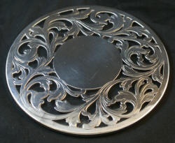 Round sterling silver and glass trivet