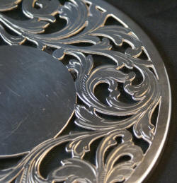 Round sterling silver and glass trivet