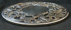 Round sterling silver and glass trivet