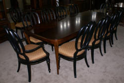 Modern Bassett Cherry dining room table and set of 12 painted black regency dining room chairs