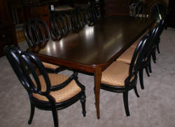 Modern Bassett Cherry dining room table and set of 12 painted black regency dining room chairs