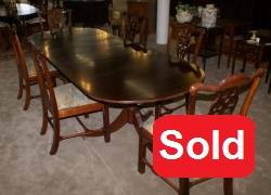 Oval banded inlaid mahogany dining room table and six solid mahogany dining room chairs