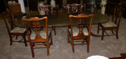 Oval banded inlaid mahogany dining room table and six solid mahogany dining room chairs