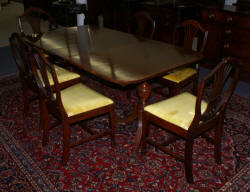 Mahogany banded inlaid Duncan Phyfe dining room table and set of six shield back dining room chairs