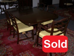 Mahogany Duncan Phyfe dining room table and set of six ribbon back dining room chairs