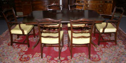 Mahogany Duncan Phyfe dining room table and set of six ribbon back dining room chairs