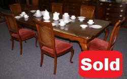 solid cherry dining room table and six cane back dining room chairs