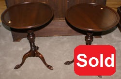 Matched pair of round paw foot side tables