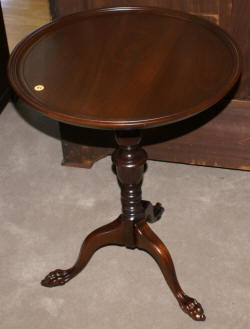 Matched pair of round paw foot side tables